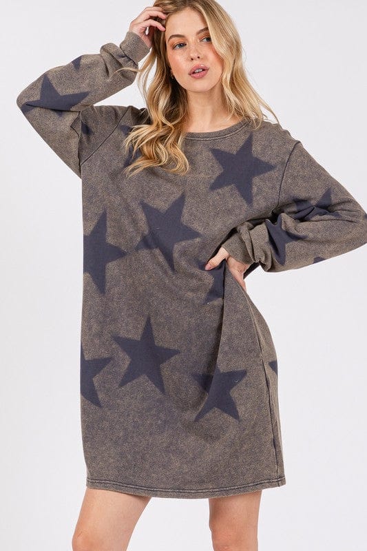  wearing the SAGE + FIG Washed Star Print Round Neck Dress, showcasing its playful star pattern and relaxed fit, set against a soft, neutral background.