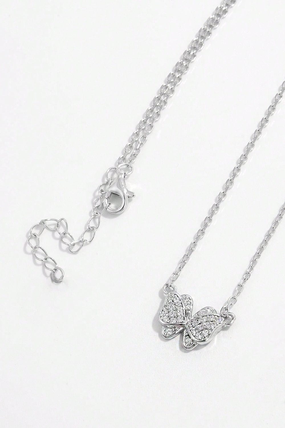 925 Sterling Silver Zircon Butterfly Pendant Necklace. The pendant is crafted in the shape of a butterfly and adorned with sparkling zircon gemstones. The necklace chain complements the pendant, showcasing its delicate beauty. This accessory exudes elegance and charm, perfect for adding a touch of sophistication to any outfit.
