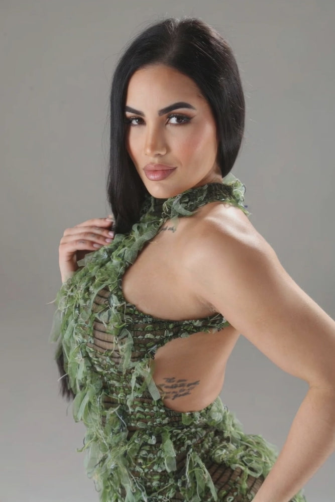 video photoshoot at unique kultureModel wearing Unique Kulture blue halter ruffled dress with open back and multi-ruffles green version close up 
