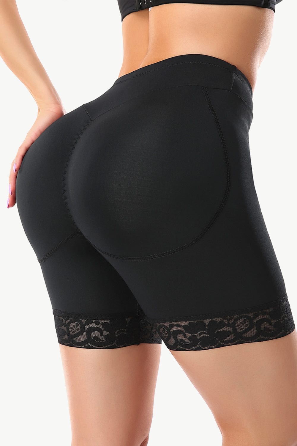 "Image of Unique Klture Full Size Lace Trim Lifting Pull-On Shaping Shorts. These high-waisted shorts feature intricate lace trim and offer comfortable pull-on styling. Designed for a flattering fit and shaping effect. Perfect blend of style and comfort for any occasion. Available in a range of sizes to cater to diverse body types."
