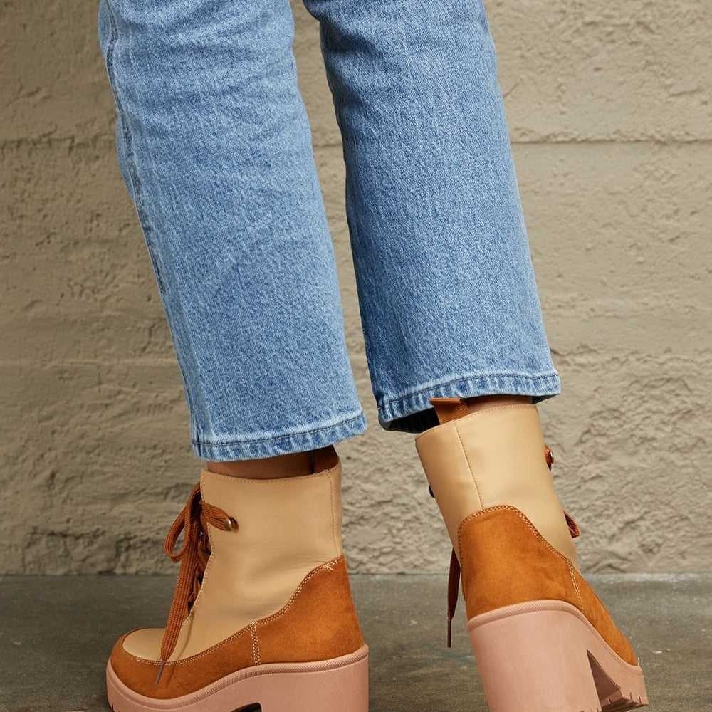  Unique Kulture East Lion Corp Lace Up Lug Booties: A pair of rugged and stylish lace-up booties from Unique Kulture's East Lion Corp collection. The boots feature a durable lug sole for traction, intricate lacing, and a blend of urban and outdoor aesthetics. These booties offer a unique combination of fashion and functionality.
