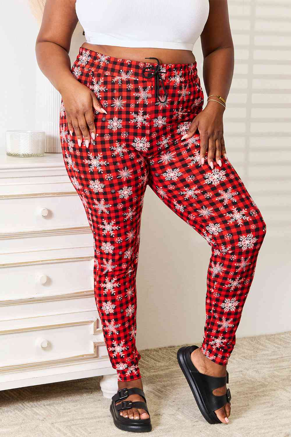 "Alt text: A close-up view of Leggings Depot Full Size Holiday Snowflake Print Joggers, featuring a festive snowflake pattern perfect for the holiday season."