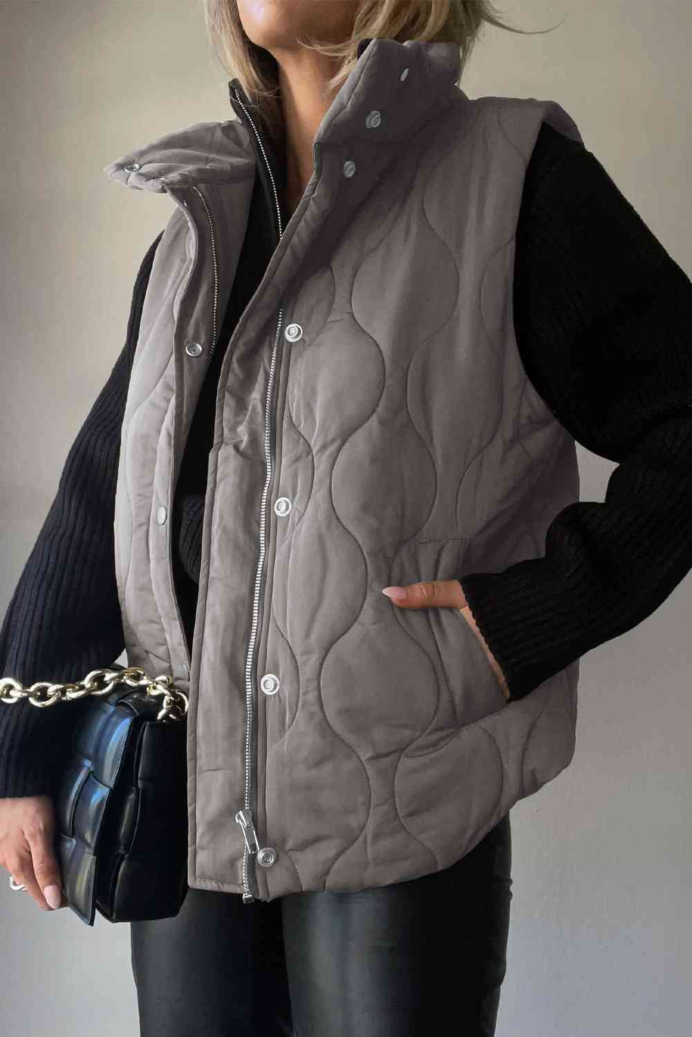 "Image: A close-up view of a stylish women's Collared Neck Vest with Pockets from Unique Kulture. The vest is made of high-quality fabric with a sleek design and features two front pockets. The collar adds a touch of sophistication to this versatile fashion piece."