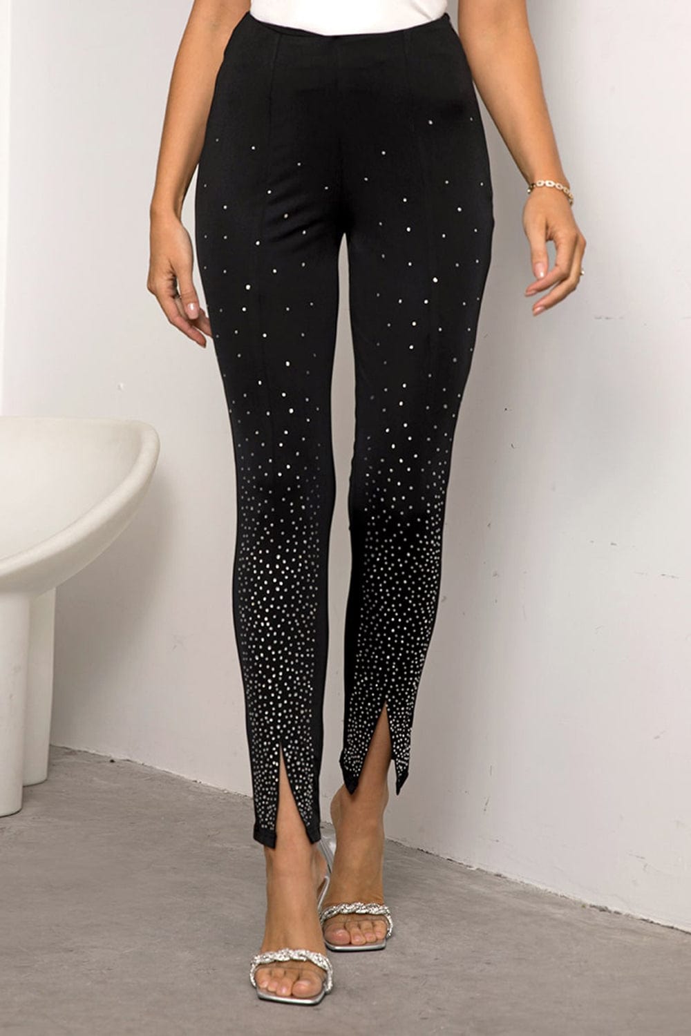 "Image: A pair of Unique Kulture High Waist Front Slit Pants. These stylish pants feature a high waist design and a front slit detail, giving them a trendy and fashionable look. The pants are made from high-quality fabric and are available in various colors and sizes, making them a versatile addition to any wardrobe."