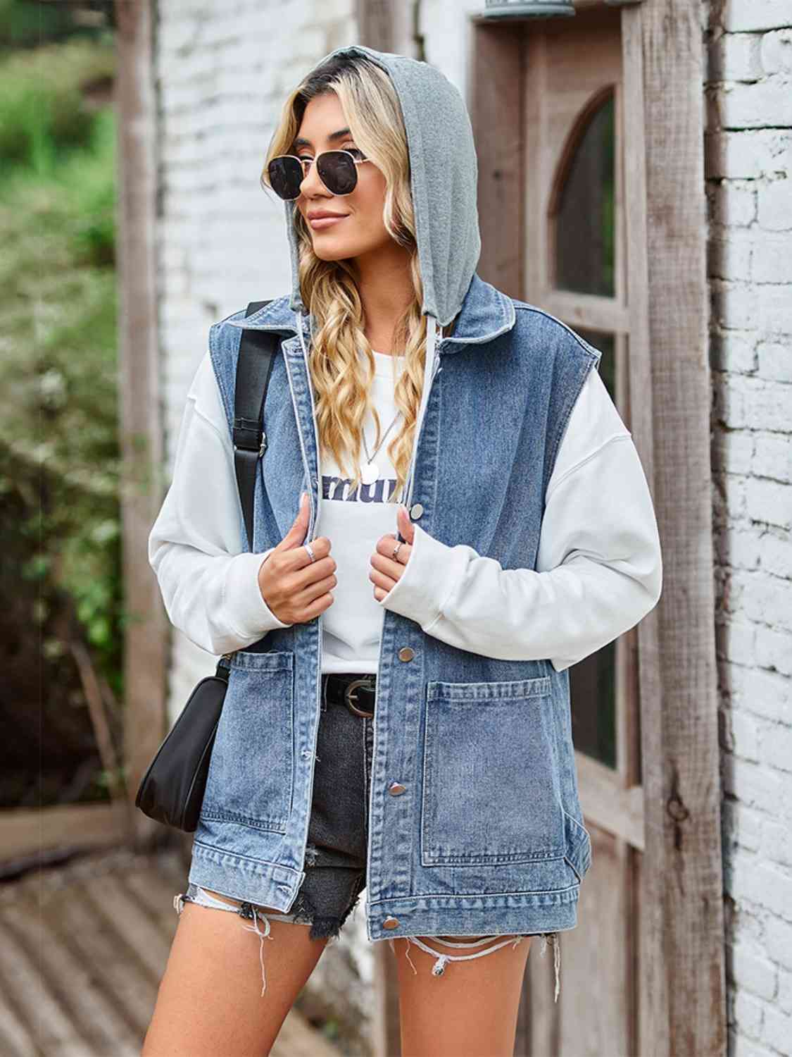 "Image of a unique Kulture designer button-up sleeveless denim jacket with pockets. The jacket features a modern and stylish design with a button-down front, sleeveless cut, and two functional pockets. The denim fabric is distressed and faded, giving it a trendy and vintage-inspired look. Perfect for adding a touch of casual yet fashionable style to any outfit."