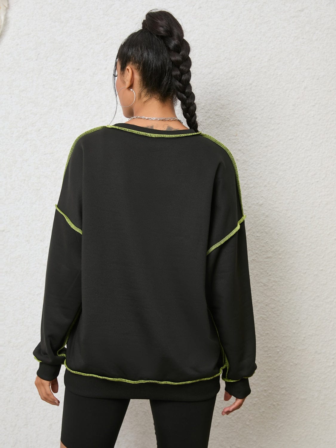 "Image description: A close-up view of a Unique Kulture Graphic Round Neck Sweatshirt. The sweatshirt features a vibrant and intricate graphic design on the front, with a mix of colors and patterns. The round neck collar and ribbed cuffs are visible, showcasing the comfortable and stylish fit. The sweatshirt is made of high-quality materials and offers a unique fashion statement."