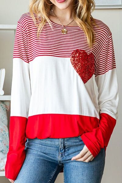 "Alt text: A stylish Striped Heart Sequin Long Sleeve T-Shirt by Unique Kulture. The shirt features a captivating design with sequin embellishments forming a heart shape on the front. The stripes add a trendy and dynamic element to the overall look, making it a fashionable and eye-catching piece of apparel."