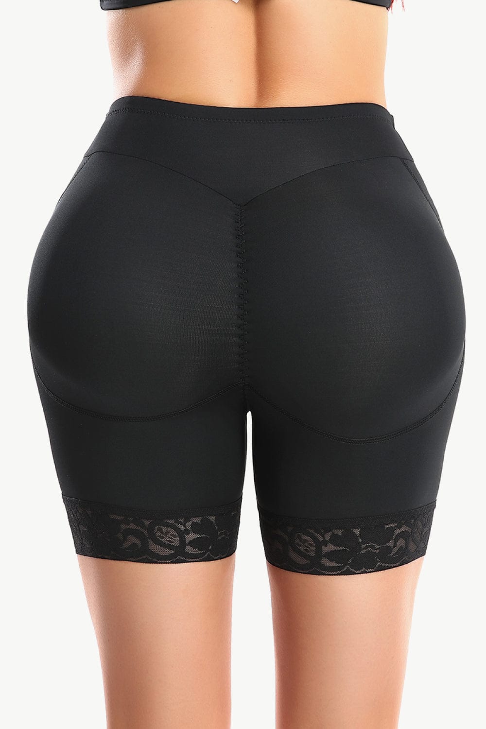 "Image of Unique Klture Full Size Lace Trim Lifting Pull-On Shaping Shorts. These high-waisted shorts feature intricate lace trim and offer comfortable pull-on styling. Designed for a flattering fit and shaping effect. Perfect blend of style and comfort for any occasion. Available in a range of sizes to cater to diverse body types."