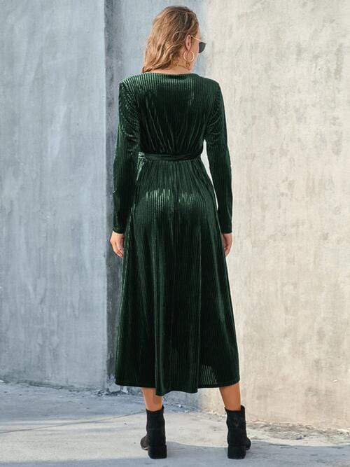 "Alt text for an image of the Unique Kulture Tie Front Long Sleeve Slit Dress. The dress is a stylish and elegant garment, showcasing a tie-front design, long sleeves, and a tasteful slit. Its high-quality fabric offers both comfort and a fashion-forward statement for various settings and events."