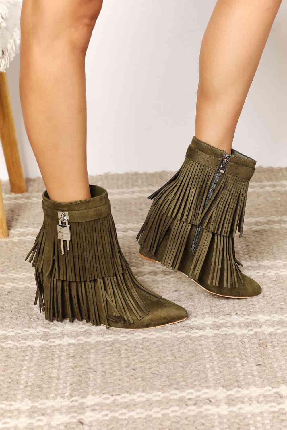 "An image featuring Legend Women's Tassel Wedge Heel Ankle Booties in [color]. The stylish booties showcase a fashionable wedge heel and are adorned with tassel details. A trendy and versatile choice for adding flair to any outfit, these ankle booties effortlessly combine fashion and comfort."