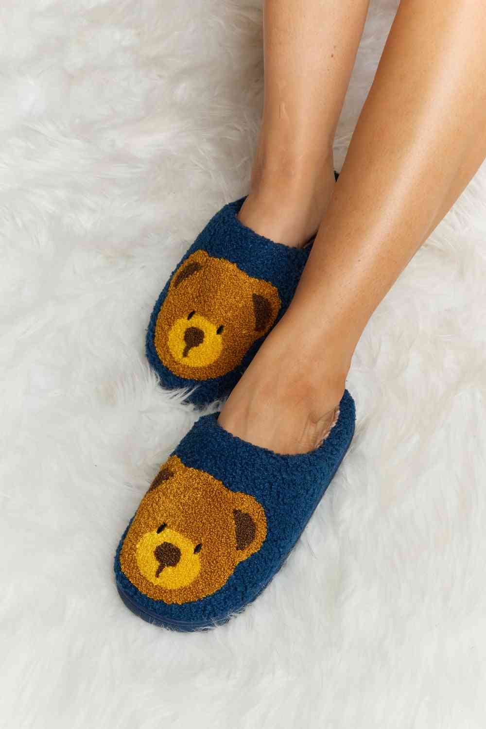 "Image of a pair of Unique Kulture Melody Teddy Bear Print Plush Slide Slippers featuring a cute teddy bear design. These cozy slippers are perfect for lounging and keeping your feet warm and stylish indoors."