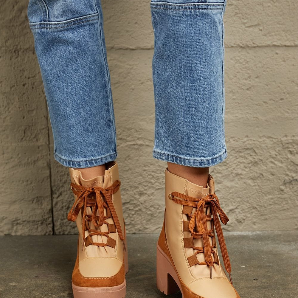  Unique Kulture East Lion Corp Lace Up Lug Booties: A pair of rugged and stylish lace-up booties from Unique Kulture's East Lion Corp collection. The boots feature a durable lug sole for traction, intricate lacing, and a blend of urban and outdoor aesthetics. These booties offer a unique combination of fashion and functionality.