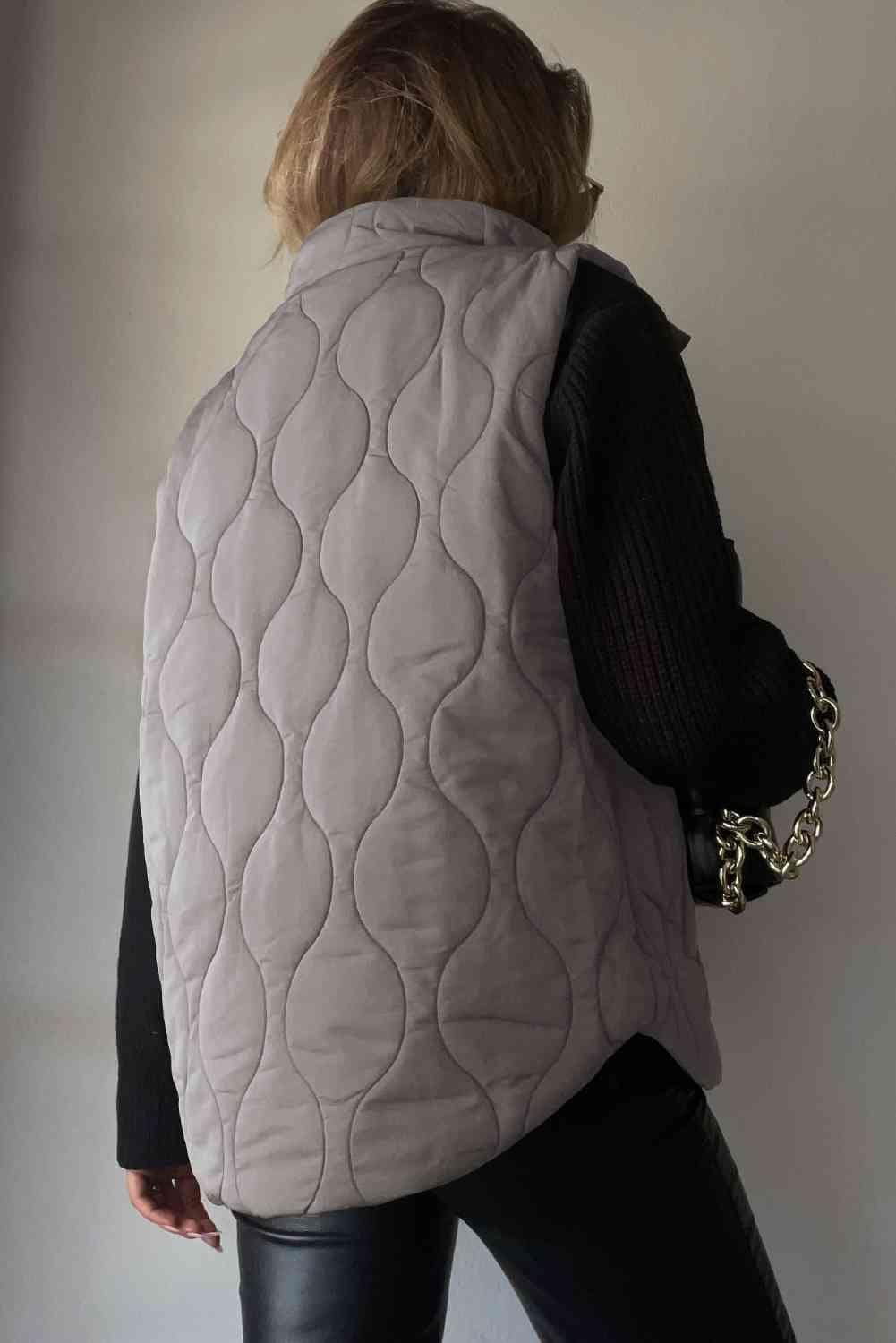 "Image: A close-up view of a stylish women's Collared Neck Vest with Pockets from Unique Kulture. The vest is made of high-quality fabric with a sleek design and features two front pockets. The collar adds a touch of sophistication to this versatile fashion piece."