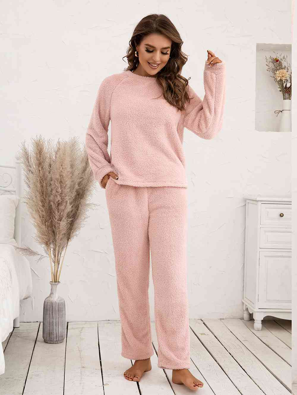 "Image: A cozy and stylish Unique Kulture Teddy Long Sleeve Top and Pants Lounge Set in a warm beige color. The top features long sleeves and a crew neck, while the pants have a comfortable, relaxed fit with an elastic waistband. This lounge set is perfect for a relaxed and comfy look for any occasion."