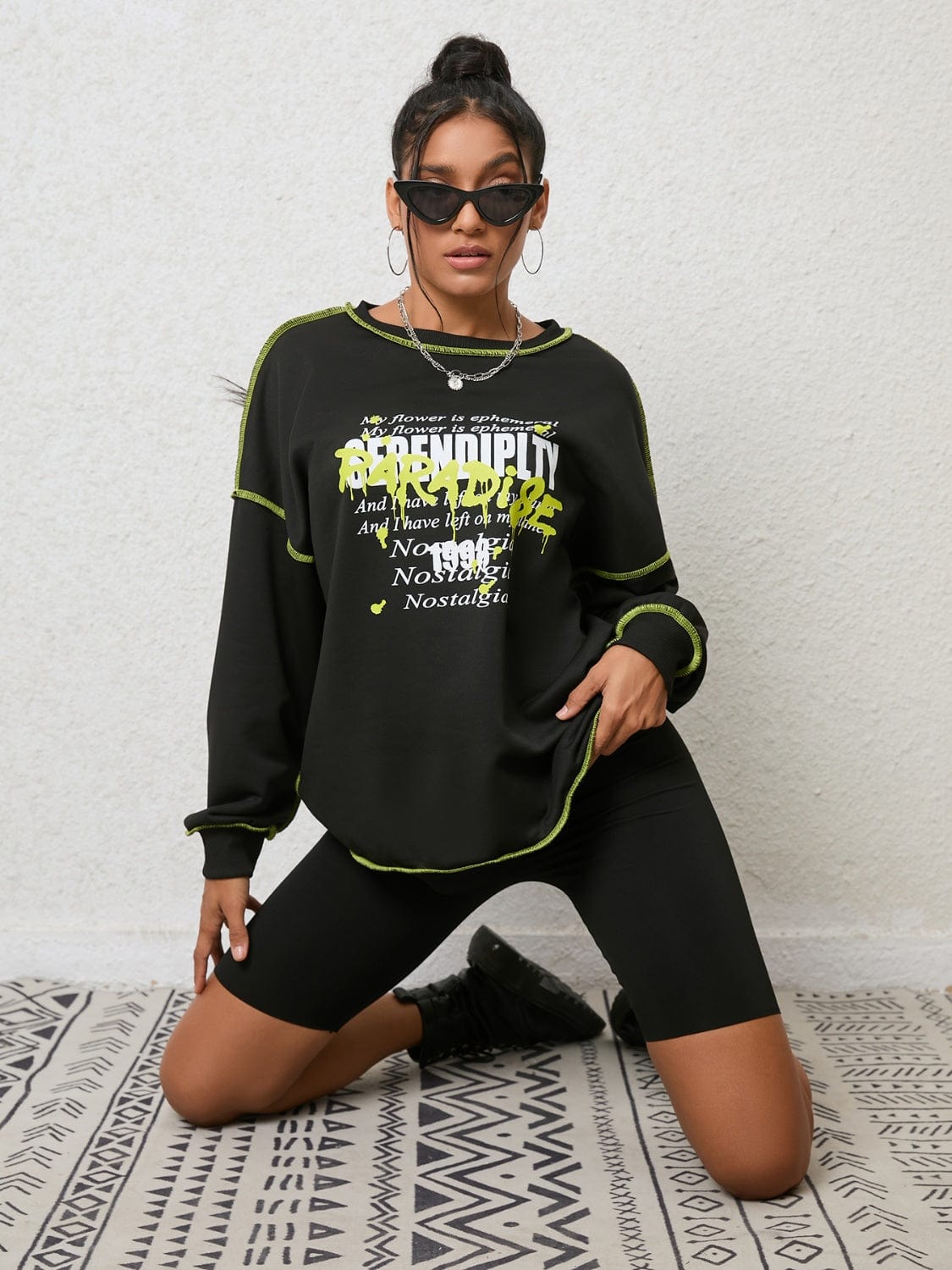 "Image description: A close-up view of a Unique Kulture Graphic Round Neck Sweatshirt. The sweatshirt features a vibrant and intricate graphic design on the front, with a mix of colors and patterns. The round neck collar and ribbed cuffs are visible, showcasing the comfortable and stylish fit. The sweatshirt is made of high-quality materials and offers a unique fashion statement."