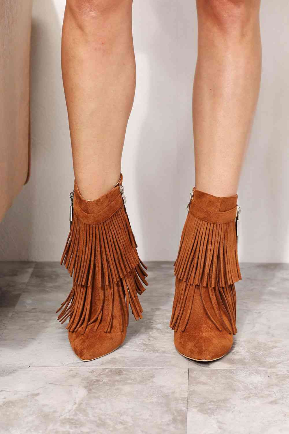 "Alt Text: A pair of stylish Legend Women's Tassel Wedge Heel Ankle Booties in a rich color, featuring a fashionable design with tassel details. The wedge heel adds height and comfort, making these booties a perfect blend of style and practicality for any occasion."