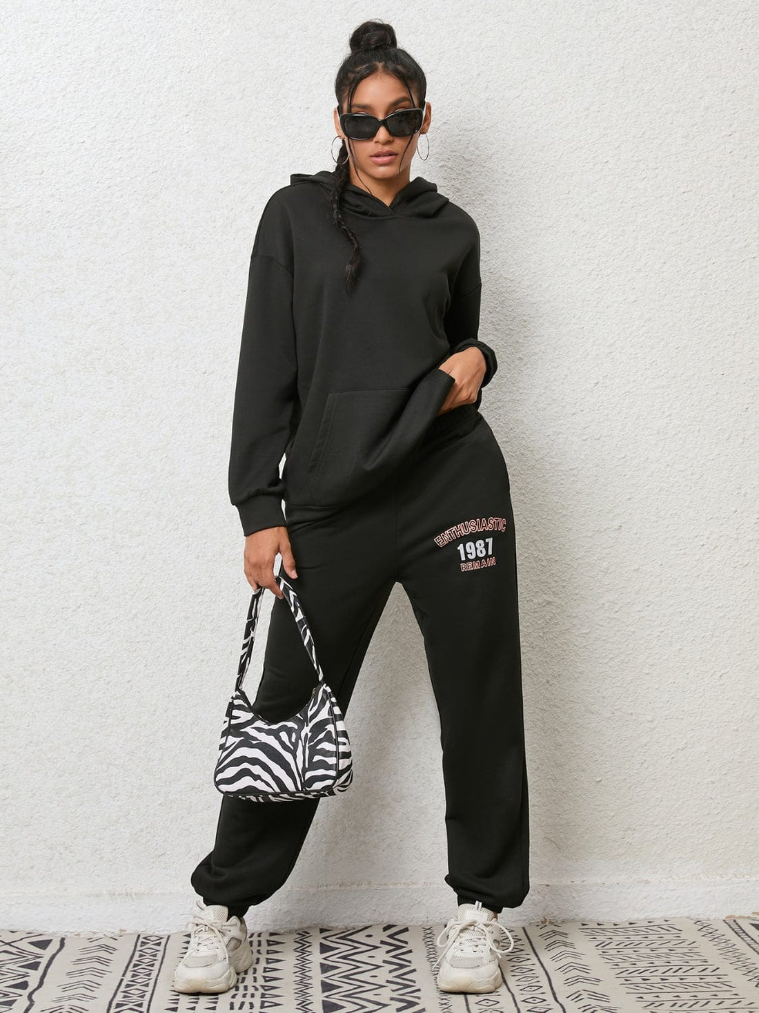 "An image featuring a stylish Unique Kulture Graphic Hoodie and Sweatpants Set. The hoodie is adorned with a vibrant and intricate graphic design, while the matching sweatpants complete the ensemble. The set exudes a trendy and urban fashion vibe, perfect for casual and comfortable wear."