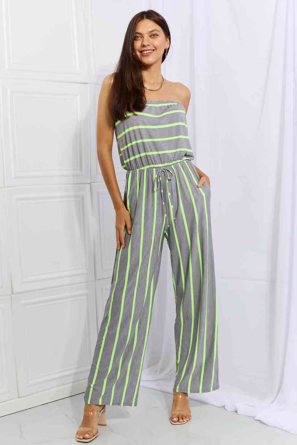 "Full-size sleeveless striped jumpsuit from Unique Kulture's Sew In Love collection. Vibrant and stylish, this jumpsuit features a pop of color, making it a trendy and eye-catching fashion choice."