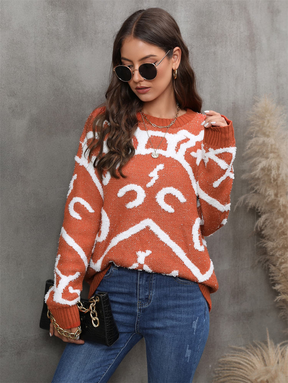 "An image of a cozy and stylish printed round neck dropped shoulder sweater. The sweater features a relaxed fit with dropped shoulder seams, creating a casual and comfortable look. The round neckline adds a touch of elegance, while the intricate print on the sweater adds a unique and fashionable element. The fabric appears soft and textured, perfect for keeping warm during colder seasons. Overall, a chic and comfortable sweater choice for a trendy and relaxed outfit."