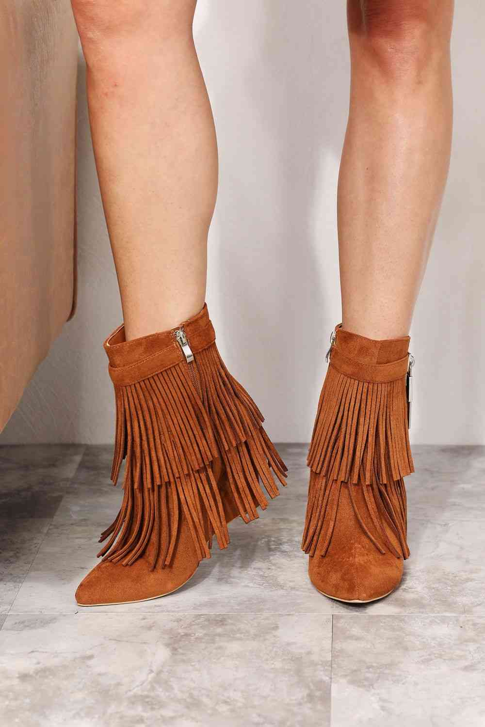 "Alt Text: A pair of stylish Legend Women's Tassel Wedge Heel Ankle Booties in a rich color, featuring a fashionable design with tassel details. The wedge heel adds height and comfort, making these booties a perfect blend of style and practicality for any occasion."